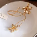 Elegant gold metal flower wrap cuff bracelet shown in close-up detail for a chic look - Arm Cuff / Gold