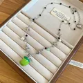 Elegant star pearl beaded necklace featuring a vibrant green apple pendant detail - Apple Pendant Necklace / Silver-Green