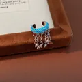 Detail view of blue stone ear cuff with silver tassels and charms for non-pierced ears. - Tassel Style Ear Clip (Single)