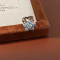 Macro view of a silver star-shaped ear clip adorned with vibrant blue zircon stones. - Star Style Ear Clip (Single)