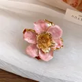 Close-up of elegant pink enamel flower stud earring with gold-toned metallic core - Ring / Eco Gold / Pink