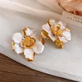 Elegant retro court style gold metal flower stud earrings with white enamel finish. - Stud Earrings / White
