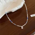 Close-up of an elegant crystal and pearl beaded necklace with an emerald-cut pendant - Necklace / Silver White