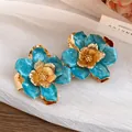 Vintage blue enamel flower stud earrings with gold metallic finish for elegant look - Stud Earrings / Blue
