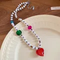 Detail of freshwater pearl necklace featuring a vibrant red heart-shaped glass pendant. - Heart Pendant / Necklace-Multicolor