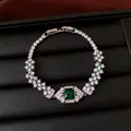 Macro detail view of vintage emerald green square zircon bracelet with floral clusters - Emerald / Silver / Bracelet