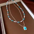 Double-layered beaded necklace with white pearls and vintage turquoise stone pendant - Double-Layer Beaded Necklace / Silver Blue