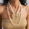 Detail view of a multi-strand pearl necklace with a large gold textured pendant. - Necklace-Gold-White-Heavy Style / 135cm