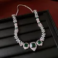 Detailed close-up of a vintage court style necklace with green square zircon pendants - Emerald / Silver / Necklace