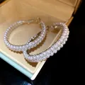Close-up of elegant pearl-encrusted hoop earrings displayed in a luxury jewelry box - Round Double Row Pearl Style (HE33440) / Silver-White
