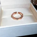 Elegant rose gold geometric open ring with a sparkling triangular zircon stone in a white box - Geometric Faceted Open Style / Rose Gold