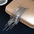 Macro detail of safety pin brooch with silver chain tassels and clear stones - Silver