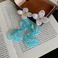 Detailed view of handmade blue chiffon flower tassel earrings with embroidered petals - Silver Earring Post-Blue