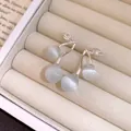 Close-up of cat's eye stone cherry earrings with zircon details on silver studs - Cherry Style (Silver Post) / Silver