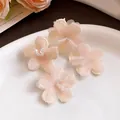 Detailed view of soft pink fabric flower stud earrings with delicate beaded centers. - Stud Earrings (Silver Post) / Pink