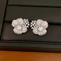 Close-up detail of silver-toned flower stud earrings encrusted with sparkling cubic zirconia - Flower Style (HE34271) / Silver