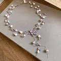 Detailansicht der zweilagigen Perlen- und Kristall-Schmetterlingskette mit Quasten. - Silber Weiß Lila