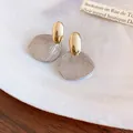 Elegant French style textured leaf stud earrings in gold and silver metallic finish - Gold and Silver