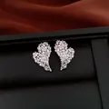Close-up detail of luxury heart stud earrings with shimmering pave zircon stones - Real Gold Plated Heart (HE34026) / Silver