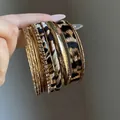 Close-up of vintage leopard print and textured gold metal bangle set for women - Leopard Set (WB1629-1) / 10-Piece Set / Gold with Coffee