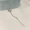 Close-up of elegant double-layered silver ear cuff with sparkling zircon and long tassel chain - Double Layer Tassel Ear Bone Clip (Single) / Silver