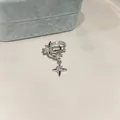 Close-up view of silver star ear cuff with clear cubic zirconia stones and dangling star - Star Ear Bone Clip (Single) / Silver