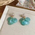 Close-up detail of elegant teal disc tassel earrings with gold wire wrapped stones - Silver Earring Post Style / Blue
