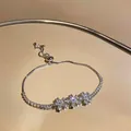 Detailed view of the three-flower zircon cluster on a gold-plated bracelet - Silver-White