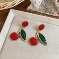 Macro view of vintage style enamel cherry earrings featuring red and green charms - Cherry Shape Drop Earrings (HE33651) / Red/Green