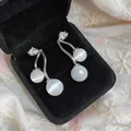 Close-up of elegant cat's eye earrings with zircon accents in black velvet box - Cherry Style / Silver