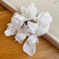 Close-up detail of the white chiffon flower petals and pearl beads on this elegant hair tie - Vacation Style Pearl Chiffon Flower / White