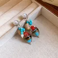 Detailed view of vintage earrings featuring pearls, turquoise stones and lampwork glass beads - Silver-Blue-Coffee