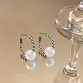 Detail view of elegant silver hoop earrings featuring white pearls and bead accents - Beaded Pearl Style / Silver