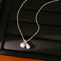 High-resolution detail shot of silver peanut pendant on a bamboo link chain necklace - Necklace (Silver)