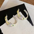 Detail of silver hoop earrings featuring yellow enamel, crystal heart and evil eye patterns - C-Shaped Heart Flower (HE32146) / Yellow