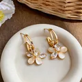 Detail view of 18k gold plated flower stud earrings with zircon and pearl accents - Flower Style (HE32283) / Gold
