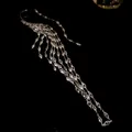 Macro detail of high-end sparkling zircon tassel ear cuff earring in golden finish - Single Piece / Silver