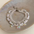 Close-up of handmade white seed bead bracelet with iridescent glass teardrops - Bracelet-White