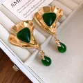 Close-up of vintage gold-tone earrings with green resin drops in jewelry box - Triangle Water Drop Pendant Style / Gold-Green