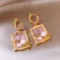 Close-up of Monet's Garden themed earrings with purple resin inlay and white pearls - Hoop-Purple / Gold