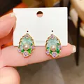 Detailed close-up of Monet-style floral pearl stud earrings with elegant 925 silver needles. - Silver Post-Gold Green Purple / Gold