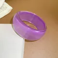 Detailed view of a purple translucent resin chunky bangle with a sparkling glitter finish - Purple