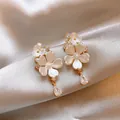 Close-up of elegant flower earrings with pearl accents and teardrop zircon dangles - Flower Water Drop Style / Gold-Beige