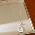 Detailed view of silver-toned necklace with teardrop pendant and stone beads - Silver-Oval