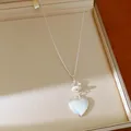 Close-up view of an elegant heart pendant necklace featuring glass stone beads and silver chain - Silver - Heart