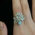 Macro view of a sweet style zircon flower vase ring with fine micro-inlaid details - Vase Floral Style (HR3074-2) / Silver/Blue