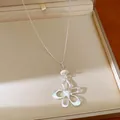 Silver-plated hollow flower pendant necklace with heart center and elegant bead. - Silver-Flower