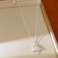 Elegant silver bell pendant necklace with heart detail in a beige jewelry gift box - Silver-Bell