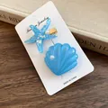 Glittery blue resin starfish and shell hair clips with faux pearl accents on card - Starfish Shell Style / Blue