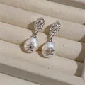 Macro detail of elegant retro earrings featuring hammered metal and rose-adorned pearls. - Rose Flower Pearl Drop / Silver & White (Silver Earring Post)